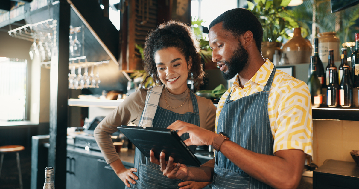 Bar and Restaurant, teamwork and people on tablet for training for inventory, menu items and checklist by bar. Business and man with woman on digital tech for hospitality, service and online ordee