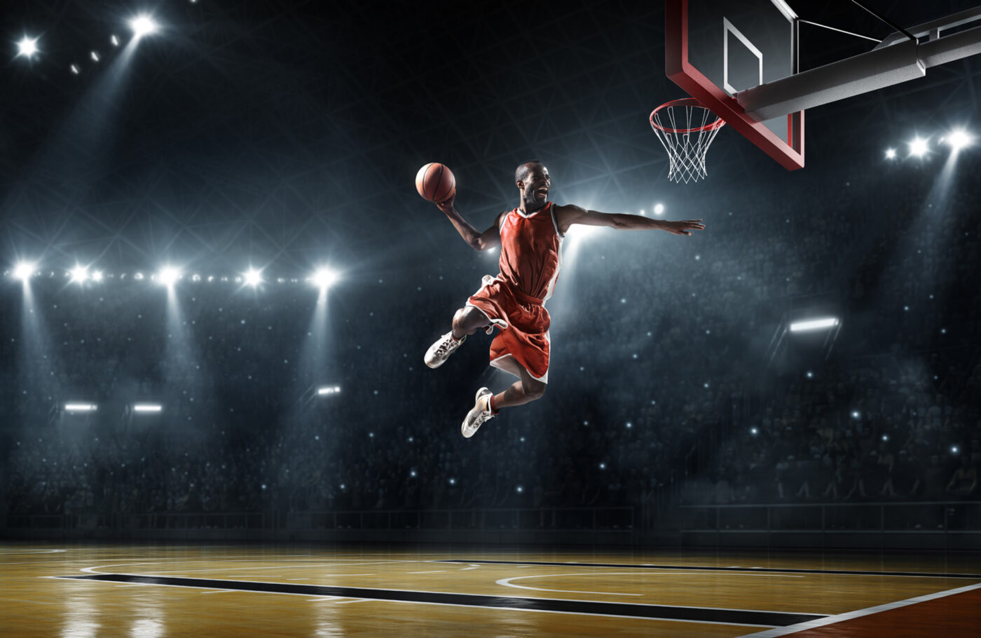 basketball hoop and basketball player dunking in dramatic lighting