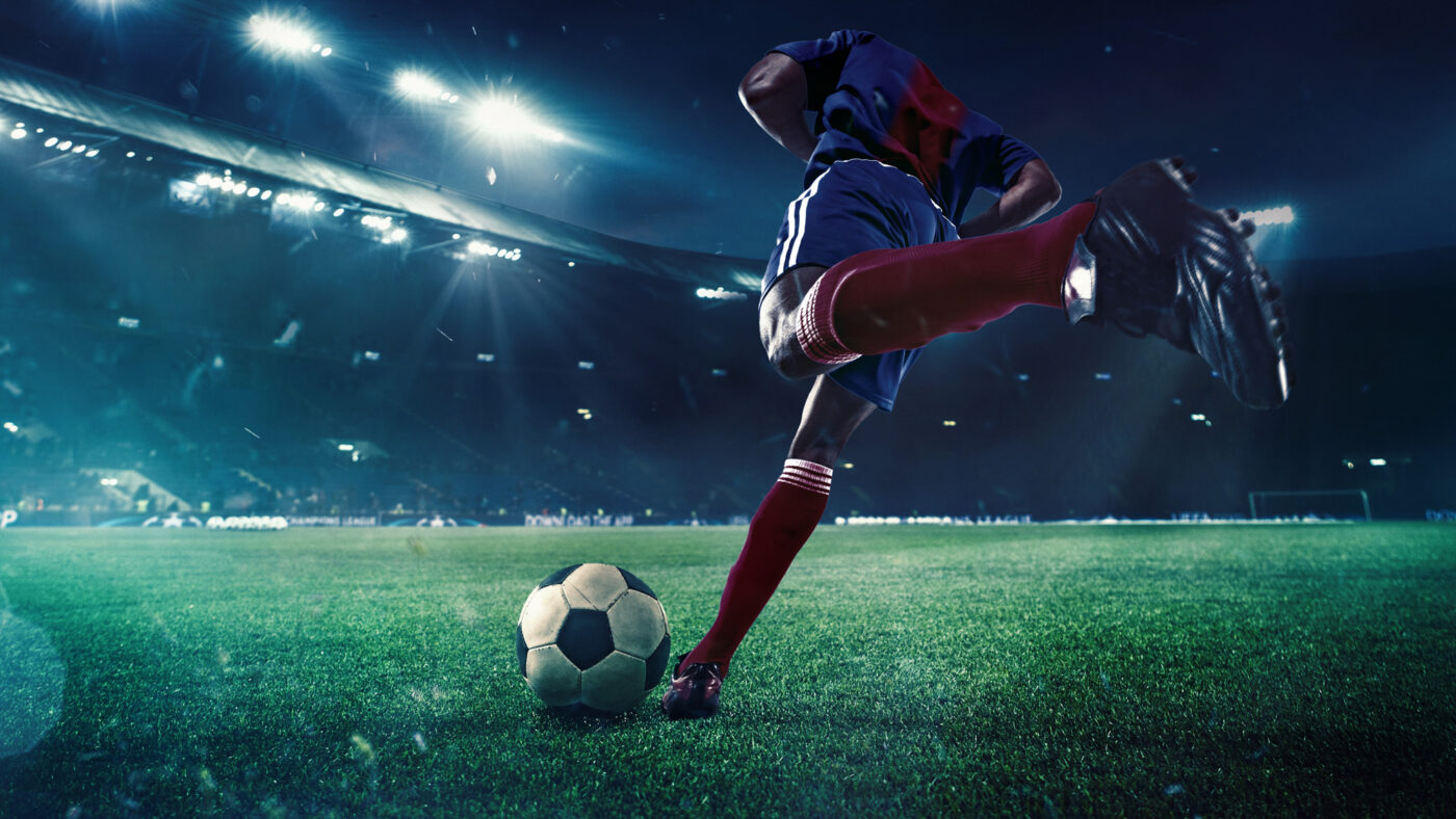 soccer player aiming to strike a ball on a 3D-rendered football field with stadium lighting, during a night match. Concept of competitive sports performance and athletic excellence ai